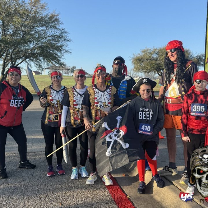 US Road Running race day photo with runners, walkers, finisher medals, and race staff