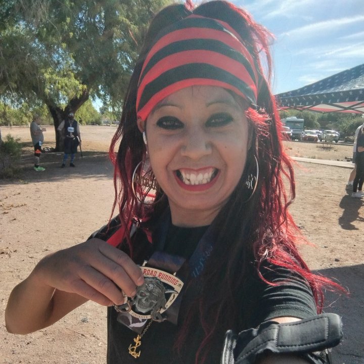 US Road Running race day photo with runners, walkers, finisher medals, and race staff