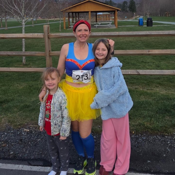 US Road Running race day photo with runners, walkers, finisher medals, and race staff