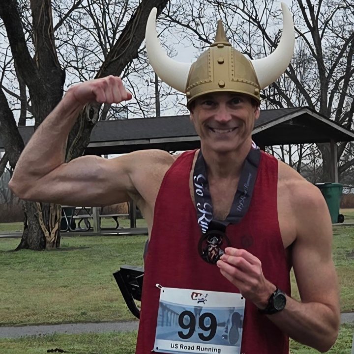 US Road Running race day photo with runners, walkers, finisher medals, and race staff