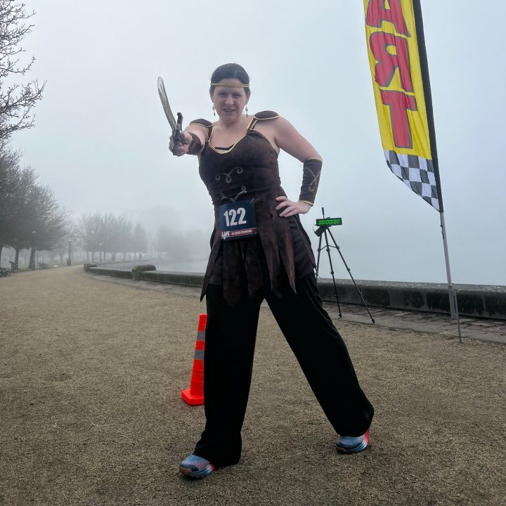 US Road Running race day photo with runners, walkers, finisher medals, and race staff