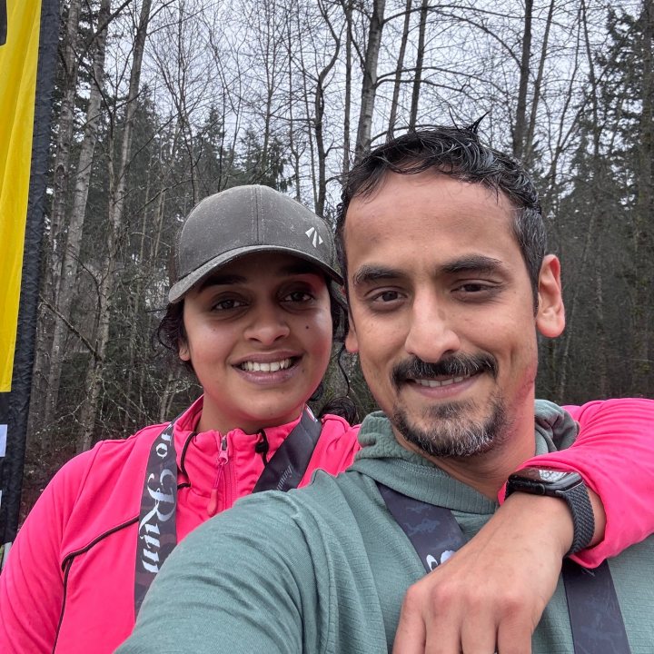 US Road Running race day photo with runners, walkers, finisher medals, and race staff