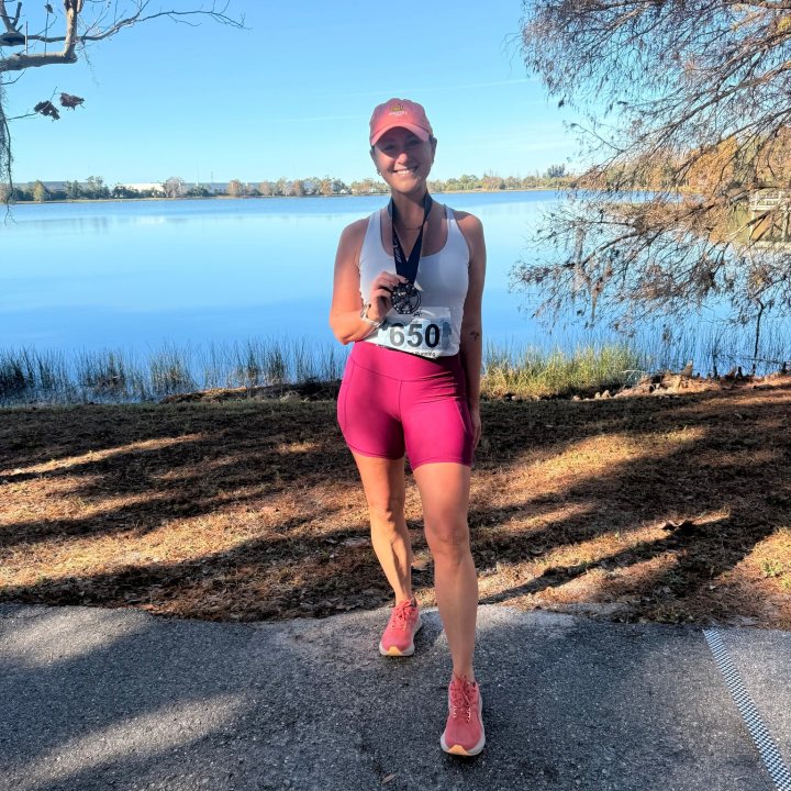 US Road Running race day photo with runners, walkers, finisher medals, and race staff