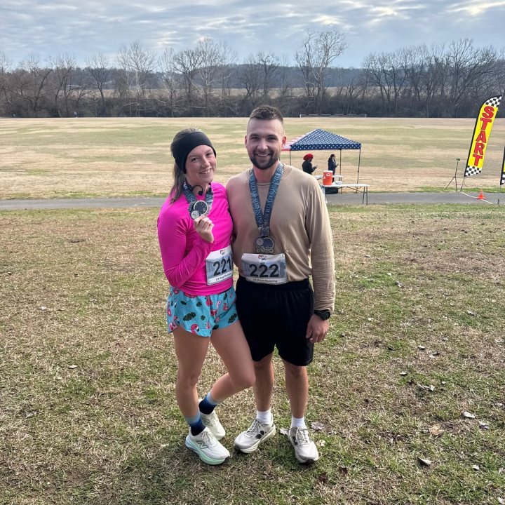 US Road Running race day photo with runners, walkers, finisher medals, and race staff
