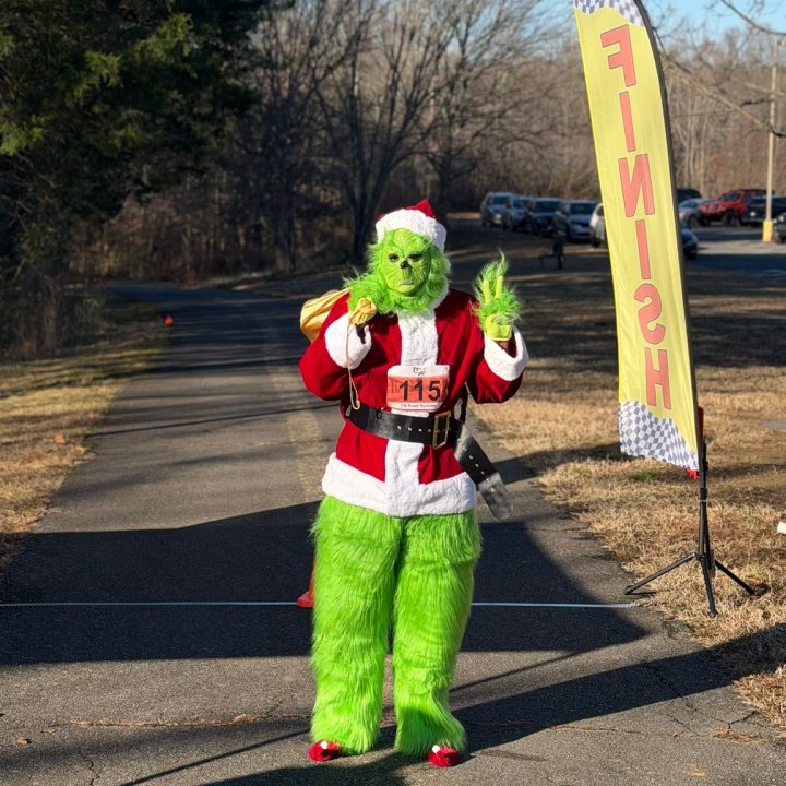 US Road Running race day photo with runners, walkers, finisher medals, and race staff