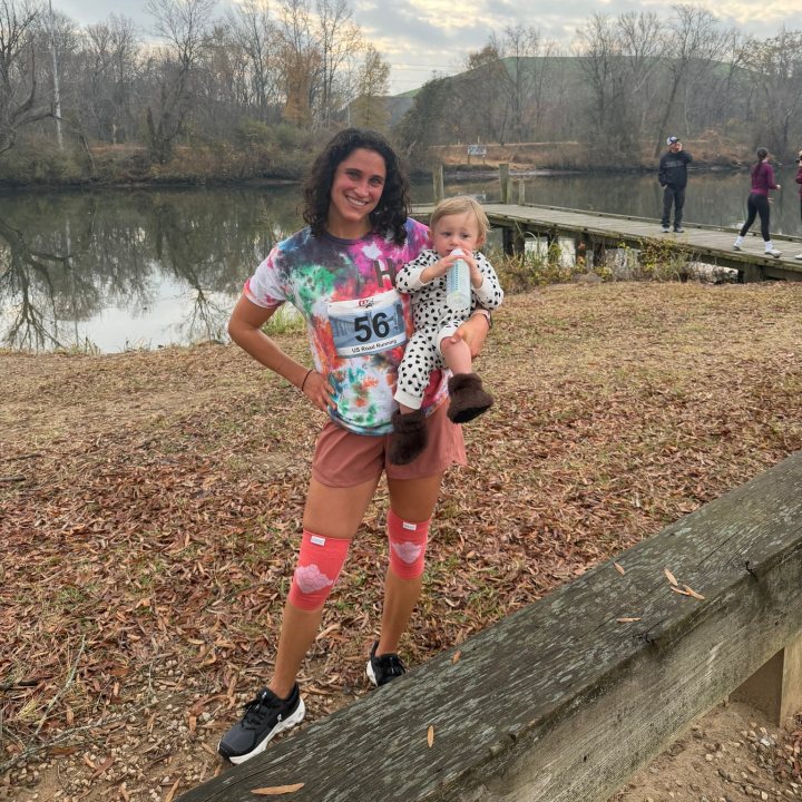 US Road Running race day photo with runners, walkers, finisher medals, and race staff