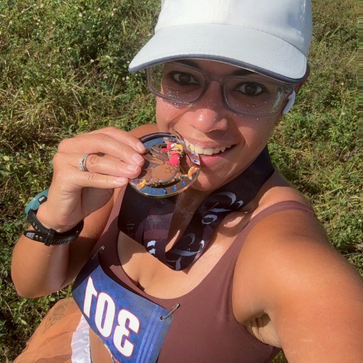 US Road Running race day photo with runners, walkers, finisher medals, and race staff