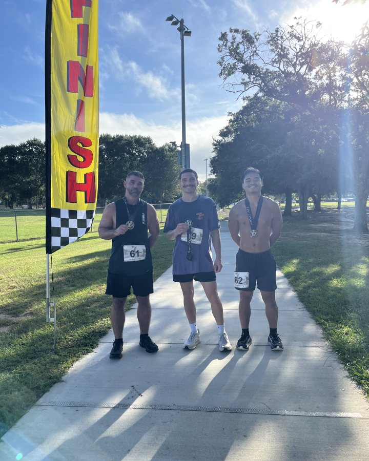 Tavian Sihavong at Haunted 5K, 10K, & 13.1M at Mobile, AL (40) - 10/03/2026 after earning 1st MALE Overall