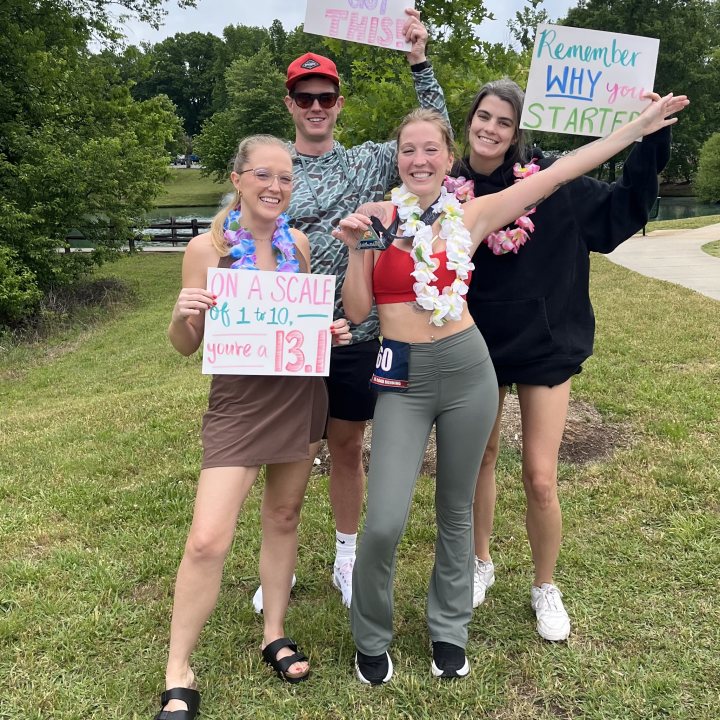 US Road Running race day photo with runners, walkers, finisher medals, and race staff